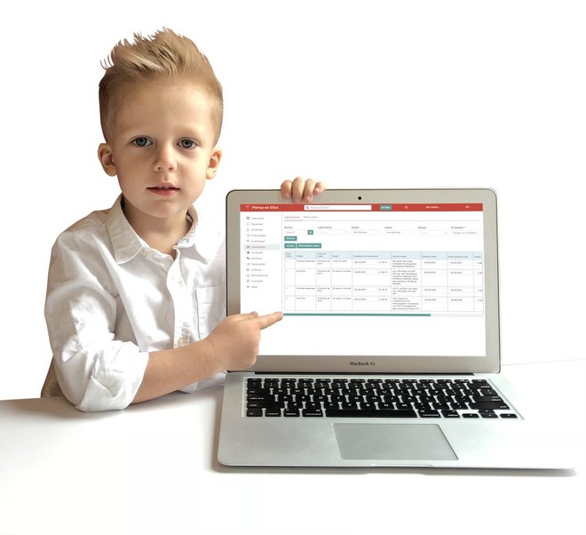 The same boy holding a tablet.